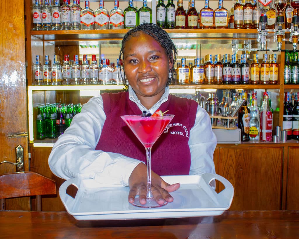 A bartender serving a cocktail